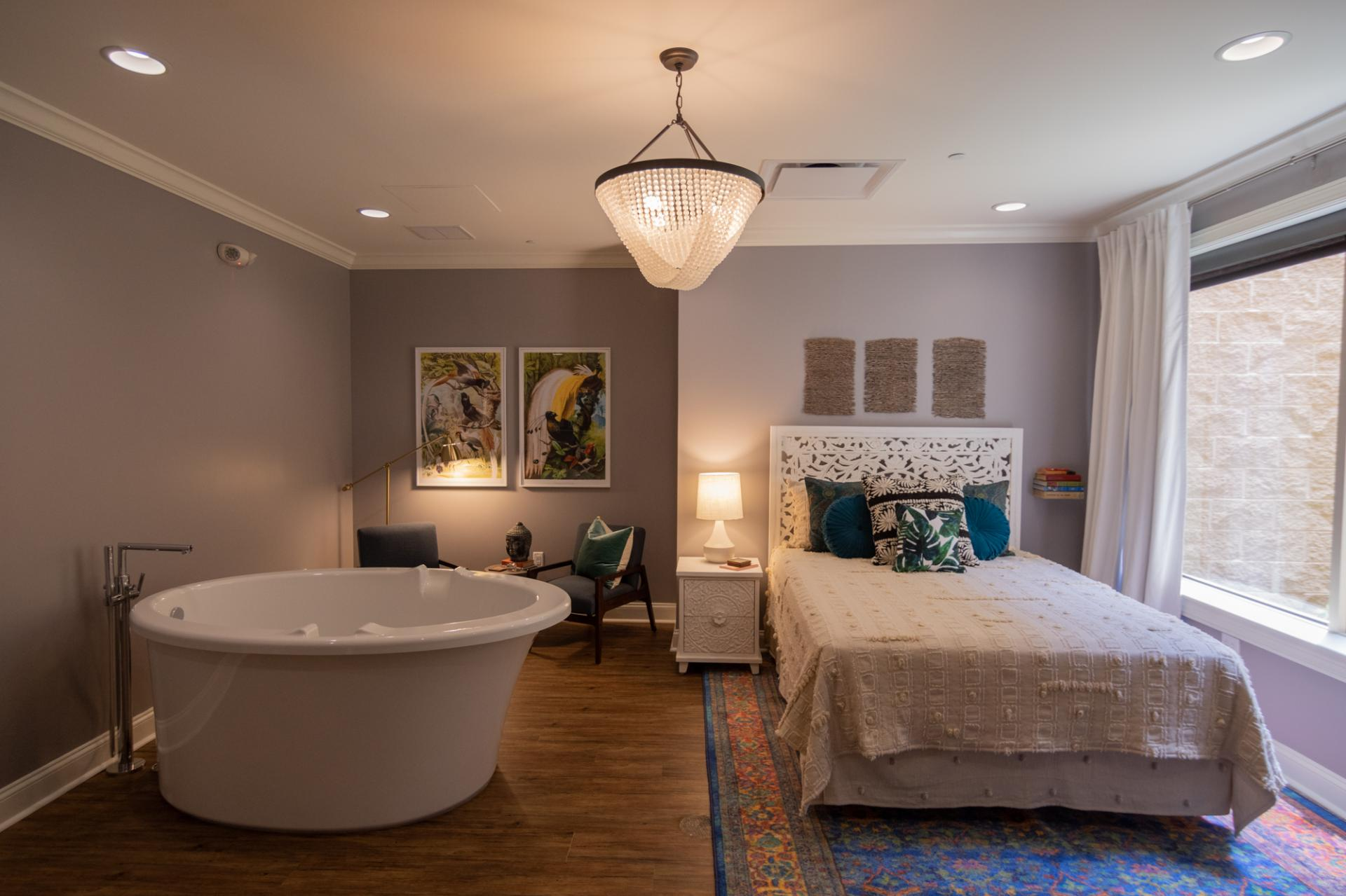 Birth Pool in a Box Unveils New White Birth Pool in a Box: A Blend of Style and Functionality 7 A birthing pool beside a bed in a warmly lit birth suite.